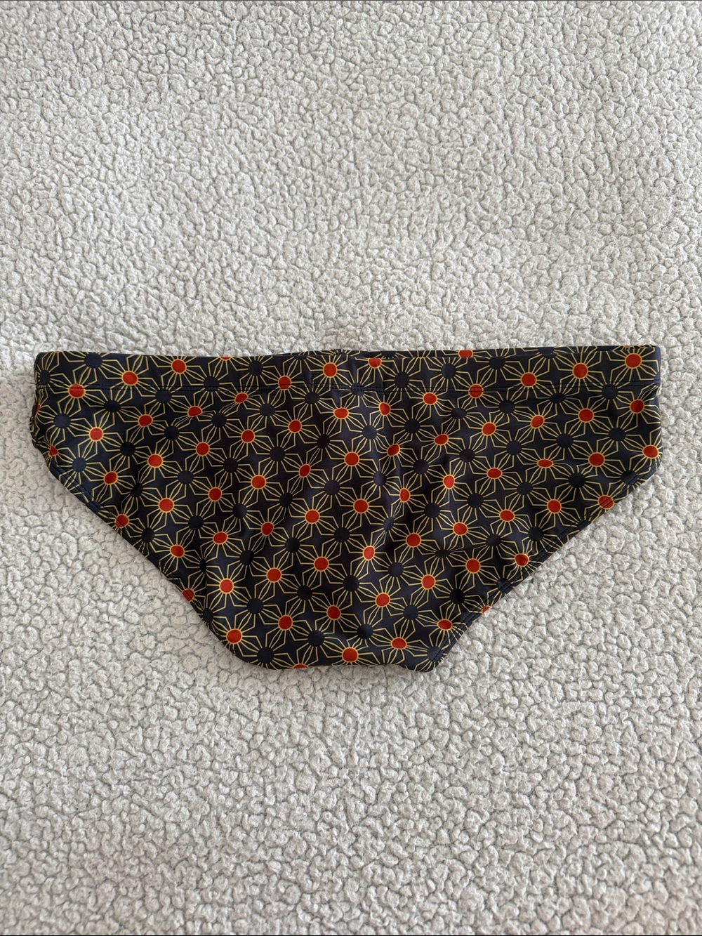 Men's Black Swim Briefs with Orange Starburst Print - Picture 2 of 6